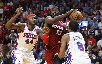 Dec 25, 2023; Miami, Florida, USA; Philadelphia 76ers forward Paul Reed (44) and  guard De'Anthony Melton (8) defend Miami Heat center Bam Adebayo (13) during the first half at Kaseya Center. Mandatory Credit: Rhona Wise-USA TODAY Sports