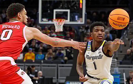 Western Kentucky Hilltoppers forward Rodney Howard (0) defends the pass of Marquette Golden Eagles guard Kam Jones (1) during NCAA Men’s Basketball Tournament game, Friday, March 22, 2024, at Gainbridge Fieldhouse in Indianapolis.