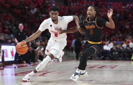 Nov 6, 2023; Houston, Texas, USA; Houston Cougars guard Mylik Wilson (8) controls the ball as Louisiana Monroe Warhawks guard Tyreke Locure (3) defends during the second half at Fertitta Center. Mandatory Credit: Troy Taormina-USA TODAY Sports