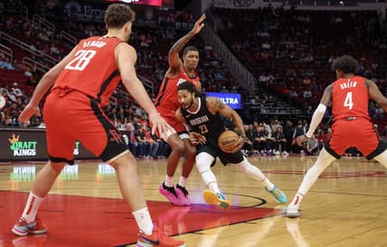 Dec 13, 2023; Houston, Texas, USA; Memphis Grizzlies guard Derrick Rose (23) splits the defense of Houston Rockets forward Jabari Smith Jr. (10) and Hguard Jalen Green (4) and against  center Alperen Sengun (28)  in the first quarter at Toyota Center. Mandatory Credit: Thomas Shea-USA TODAY Sports