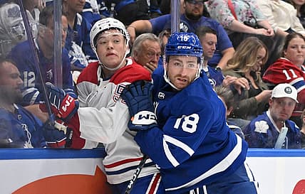Oct 2, 2023; Toronto, Ontario, CAN;  Toronto Maple Leafs forward Noah Gregor (18) bodychecks Montreal Canadiens defenseman Jordan Harris (54) the third period at Scotiabank Arena. Mandatory Credit: Dan Hamilton-USA TODAY Sports