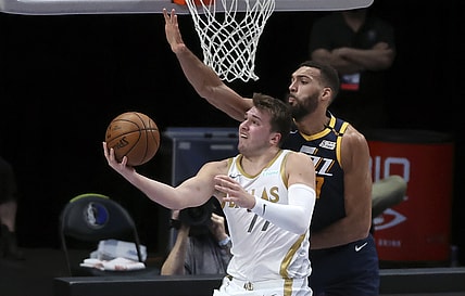 Apr 5, 2021; Dallas, Texas, USA; Dallas Mavericks guard Luka Doncic (77) shoots as Utah Jazz center Rudy Gobert (27) defends during the first half against the Utah Jazz at American Airlines Center. Mandatory Credit: Kevin Jairaj-USA TODAY Sports