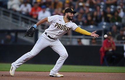 Aug 10, 2021; San Diego, California, USA; San Diego Padres first baseman Eric Hosmer (30) tosses the ball to first base on a ground out by Miami Marlins shortstop Miguel Rojas (not pictured) during the first inning at Petco Park. Mandatory Credit: Orlando Ramirez-USA TODAY Sports