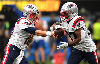 Oct 31, 2021; Inglewood, California, USA; New England Patriots quarterback Mac Jones (left) hands the ball off to running back Damien Harris (right) during the first quarter at SoFi Stadium. Mandatory Credit: Orlando Ramirez-USA TODAY Sports