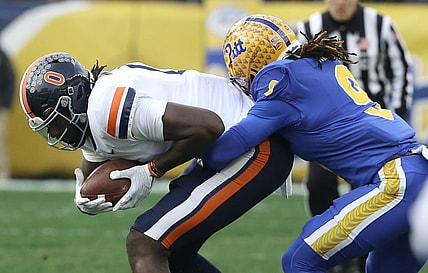 Nov 20, 2021; Pittsburgh, Pennsylvania, USA;  Virginia Cavaliers tight end Jelani Woods (0) is tackled after a catch against Pittsburgh Panthers defensive back Brandon Hill (9) during the first quarter at Heinz Field. Mandatory Credit: Charles LeClaire-USA TODAY Sports