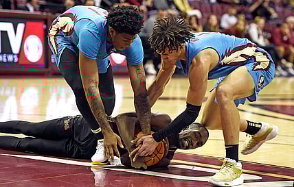 Nov 21, 2022; Tallahassee, Florida, USA; Mercer Bears guard Shawn Walker (25) fights for a loose ball with Florida State Seminoles guard Cam'Ron Fletcher (21) and guard Jalen Warley (1) during the first half at Donald L. Tucker Center. Mandatory Credit: Melina Myers-USA TODAY Sports