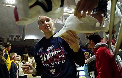 Feb 27, 2023; Storrs, Connecticut, USA; UConn Huskies guard Paige Bueckers (5) signs autographs after her teammates defeated the Xavier Musketeers at Harry A. Gampel Pavilion. Mandatory Credit: David Butler II-USA TODAY Sports