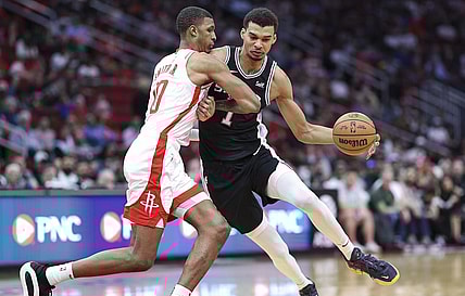 Mar 5, 2024; Houston, Texas, USA; San Antonio Spurs center Victor Wembanyama (1) controls the ball as Houston Rockets forward Jabari Smith Jr. (10) defends during the first quarter at Toyota Center. Mandatory Credit: Troy Taormina-USA TODAY Sports