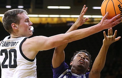 Iowa   s Payton Sandfort (20) and Kansas State   s Tylor Perry (2) reach for a loose ball in a first-round NIT game Tuesday, March 19, 2024 at Carver-Hawkeye Arena in Iowa City, Iowa.