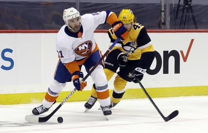 May 16, 2021; Pittsburgh, Pennsylvania, USA; New York Islanders right wing Kyle Palmieri (21) moves the puck against Pittsburgh Penguins right wing Kasperi Kapanen (42) during the first period in game one of the first round of the 2021 Stanley Cup Playoffs at PPG Paints Arena. Mandatory Credit: Charles LeClaire-USA TODAY Sports