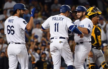 Aug 18, 2021; Los Angeles, California, USA; Los Angeles Dodgers first baseman Max Muncy (second from right) is congratulated by left fielder A.J. Pollock (11) and relief pitcher Mitch White (66) after hitting a three-run home run against the Pittsburgh Pirates during the fourth inning at Dodger Stadium. Mandatory Credit: Richard Mackson-USA TODAY Sports