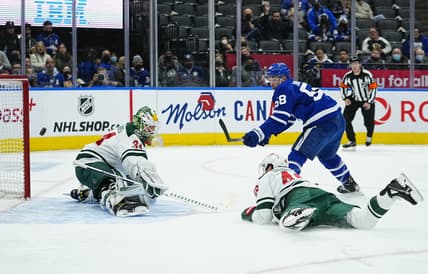 Feb 24, 2022; Toronto, Ontario, CAN; Minnesota Wild goaltender Kaapo Kahkonen (34) makes a save on Toronto Maple Leafs forward Michael Bunting (58) as Minnesota Wild defenseman Jared Spurgeon (46) dives to help out during the first period at Scotiabank Arena. Mandatory Credit: John E. Sokolowski-USA TODAY Sports