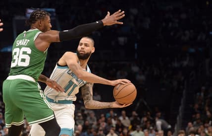 Mar 9, 2022; Charlotte, North Carolina, USA;  Charlotte Hornets guard forward Cody Martin (11) looks to pass as he is defended by Boston Celtics guard Marcus Smart (36)  during the first half at the Spectrum Center. Mandatory Credit: Sam Sharpe-USA TODAY Sports