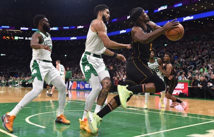 Mar 30, 2022; Boston, Massachusetts, USA; Boston Celtics forward Jayson Tatum (0) fouls Miami Heat forward Jimmy Butler (22) during the first half at TD Garden. Mandatory Credit: Bob DeChiara-USA TODAY Sports