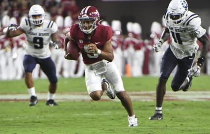 Sep 3, 2022; Tuscaloosa, Alabama, USA;  Alabama Crimson Tide quarterback Bryce Young (9) outruns Utah State defensive lineman Daniel Grzesiak (9) and Utah State defensive lineman Byron Vaughns (11) at Bryant-Denny Stadium. Mandatory Credit: Gary Cosby Jr.-USA TODAY Sports