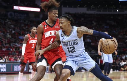 Oct 21, 2022; Houston, Texas, USA; Memphis Grizzlies guard Ja Morant (12) controls the ball as Houston Rockets guard Jalen Green (4) defends during the first quarter at Toyota Center. Mandatory Credit: Troy Taormina-USA TODAY Sports