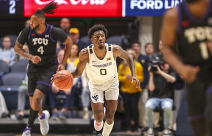 Jan 18, 2023; Morgantown, West Virginia, USA; West Virginia Mountaineers guard Kedrian Johnson (0) dribbles up the court during the second half against the TCU Horned Frogs at WVU Coliseum. Mandatory Credit: Ben Queen-USA TODAY Sports