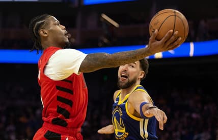 Feb 28, 2023; San Francisco, California, USA; Portland Trail Blazers forward Cam Reddish (5) shoots around Golden State Warriors guard Klay Thompson (11) during the second quarter at Chase Center. Mandatory Credit: D. Ross Cameron-USA TODAY Sports