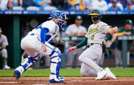 May 6, 2023; Kansas City, Missouri, USA; Oakland Athletics shortstop Kevin Smith (4) scores a run against Kansas City Royals catcher Freddy Fermin (34) during the fourth inning at Kauffman Stadium. Mandatory Credit: Jay Biggerstaff-USA TODAY Sports