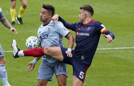 Oct 17, 2020; Chicago, Illinois, USA; Chicago Fire defender Francisco Calvo (5) kicks the ball away from Sporting Kansas City forward Erik Hurtado (19) during the second half at Soldier Field. Mandatory Credit: Mike Dinovo-USA TODAY Sports