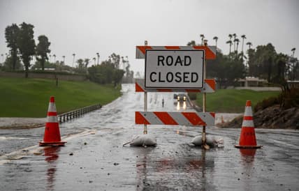 Country Club Drive is seen closed at the storm channel in Rancho Mirage, Calif., Sunday, Aug. 20, 2023.