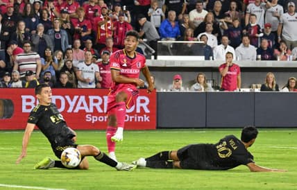 Sep 20, 2023; St. Louis, Missouri, USA; St. Louis City forward Nicholas Gioacchini (11) shoots against Los Angeles FC defender Sergi Palencia (30) and forward Carlos Vela (10) during the second half at CITYPARK. Mandatory Credit: Scott Rovak-USA TODAY Sports