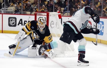 Jan 15, 2024; Pittsburgh, Pennsylvania, USA; Pittsburgh Penguins goaltender Tristan Jarry (35) makes a save against Seattle Kraken Jaden Schwartz (right) during the second period at PPG Paints Arena. Mandatory Credit: Charles LeClaire-USA TODAY Sports