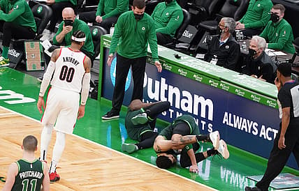 May 2, 2021; Boston, Massachusetts, USA; Boston Celtics forward Jayson Tatum (0) and guard Jaylen Brown (7) fall to the ground as head coach Brad Stevens looks on as they take on the Portland Trail Blazers in the fourth quarter at TD Garden. Mandatory Credit: David Butler II-USA TODAY Sports