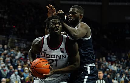 Jan 25, 2022; Storrs, Connecticut, USA; Connecticut Huskies forward Adama Sanogo (21) works the ball again st Georgetown Hoyas center Timothy Ighoefe (5) in the first half at Harry A. Gampel Pavilion. Mandatory Credit: David Butler II-USA TODAY Sports