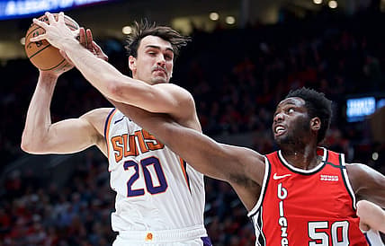 Mar 10, 2020; Portland, OR, USA; Phoenix Suns forward Dario Saric (20) and Portland Trail Blazers forward Caleb Swanigan (50) battle for a rebound during the second quarter at the Moda Center. Mandatory Credit: Craig Mitchelldyer-USA TODAY Sports