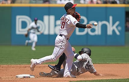 Jul 3, 2022; Cleveland, Ohio, USA; Cleveland Guardians second baseman Andres Gimenez (0) forces out New York Yankees third baseman Josh Donaldson (28) during the fourth inning at Progressive Field. Mandatory Credit: Ken Blaze-USA TODAY Sports