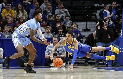Dec 30, 2022; Pittsburgh, Pennsylvania, USA; North Carolina Tar Heels forward Leaky Black (left) and Pittsburgh Panthers guard Greg Elliott (3) reach for a loose ball during the first half at Petersen Events Center. Mandatory Credit: Charles LeClaire-USA TODAY Sports
