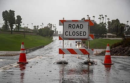 Country Club Drive is seen closed at the storm channel in Rancho Mirage, Calif., Sunday, Aug. 20, 2023.