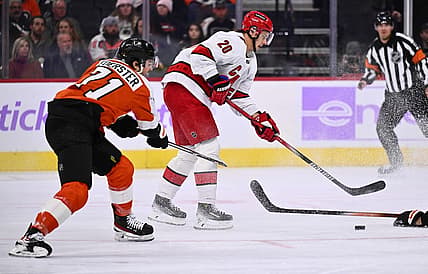 Nov 28, 2023; Philadelphia, Pennsylvania, USA; Carolina Hurricanes center Sebastian Aho (20) reaches for the puck against Philadelphia Flyers right wing Tyson Foerster (71) in the first period at Wells Fargo Center. Mandatory Credit: Kyle Ross-USA TODAY Sports