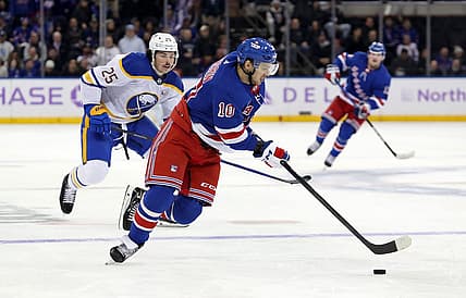 Nov 27, 2023; New York, New York, USA; New York Rangers left wing Artemi Panarin (10) skates with the puck in front of Buffalo Sabres defenseman Owen Power (25) during the second period at Madison Square Garden. Mandatory Credit: Danny Wild-USA TODAY Sports