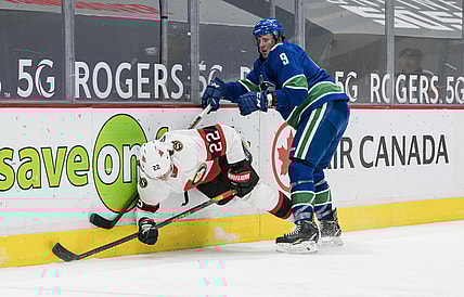 Jan 27, 2021; Vancouver, British Columbia, CAN; Vancouver Canucks forward J.T. Miller (9) checks Ottawa Senators defenseman Nikita Zaitsev (22) in the third period at Rogers Arena. Vancouver won 5-1. Mandatory Credit: Bob Frid-USA TODAY Sports