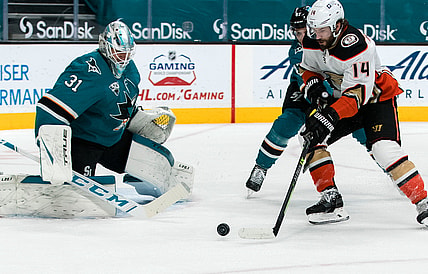 Apr 12, 2021; San Jose, California, USA; Anaheim Ducks center Adam Henrique (14) shoots the puck against San Jose Sharks goaltender Martin Jones (31) in the first period at SAP Center at San Jose. Mandatory Credit: John Hefti-USA TODAY Sports