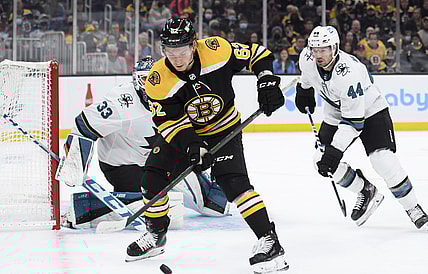 Oct 24, 2021; Boston, Massachusetts, USA;  Boston Bruins center Oskar Steen (62) controls the puck in front of San Jose Sharks goaltender Adin Hill (33) while defenseman Marc-Edouard Vlasic (44) defends during the first period at TD Garden. Mandatory Credit: Bob DeChiara-USA TODAY Sports
