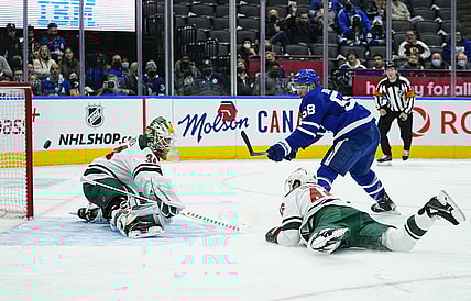 Feb 24, 2022; Toronto, Ontario, CAN; Minnesota Wild goaltender Kaapo Kahkonen (34) makes a save on Toronto Maple Leafs forward Michael Bunting (58) as Minnesota Wild defenseman Jared Spurgeon (46) dives to help out during the first period at Scotiabank Arena. Mandatory Credit: John E. Sokolowski-USA TODAY Sports