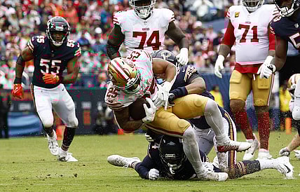 Sep 11, 2022; Chicago, Illinois, USA; San Francisco 49ers running back Elijah Mitchell (25) rushes the ball against Chicago Bears safety Jaquan Brisker (9) during the first half at Soldier Field. Mandatory Credit: Mike Dinovo-USA TODAY Sports