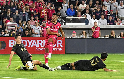 Sep 20, 2023; St. Louis, Missouri, USA; St. Louis City forward Nicholas Gioacchini (11) shoots against Los Angeles FC defender Sergi Palencia (30) and forward Carlos Vela (10) during the second half at CITYPARK. Mandatory Credit: Scott Rovak-USA TODAY Sports