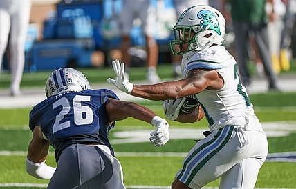 Oct 28, 2023; Houston, Texas, USA; Tulane Green Wave running back Makhi Hughes (21) stiff arms Rice Owls safety Gabriel Taylor (26) in the first half at Rice Stadium. Mandatory Credit: Thomas Shea-USA TODAY Sports