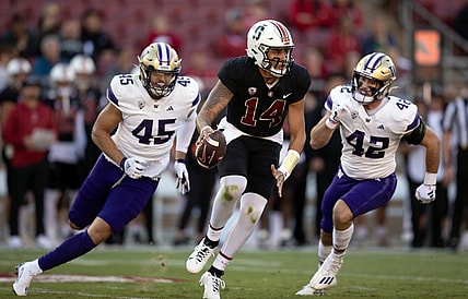Oct 28, 2023; Stanford, California, USA; Stanford Cardinal quarterback Ashton Daniels (14) scrambles away from defensive pressure by Washington Huskies edge rusher Maurice Heims (45) and linebacker Carson Bruener (42) during the first quarter at Stanford Stadium. Mandatory Credit: D. Ross Cameron-USA TODAY Sports