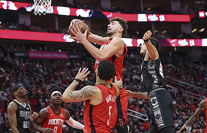 Dec 11, 2023; Houston, Texas, USA; Houston Rockets center Alperen Sengun (28) grabs a rebound during the third quarter against the San Antonio Spurs at Toyota Center. Mandatory Credit: Troy Taormina-USA TODAY Sports
