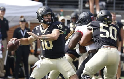 Oct 2, 2021; Winston-Salem, North Carolina, USA;  Wake Forest Demon Deacons quarterback Sam Hartman (10) throws a pass as offensive lineman Zach Tom (50) blocks during the first quarter against the Louisville Cardinals at Truist Field. Mandatory Credit: Reinhold Matay-USA TODAY Sports