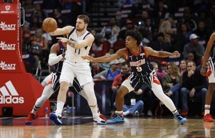 Mar 11, 2022; Houston, Texas, USA; Dallas Mavericks guard Luka Doncic (77) passes the ball away from Houston Rockets guard Josh Christopher (9) during the second quarter at Toyota Center. Mandatory Credit: Troy Taormina-USA TODAY Sports