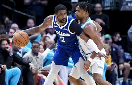 Mar 24, 2023; Dallas, Texas, USA;  Dallas Mavericks guard Kyrie Irving (2) controls the ball as Charlotte Hornets guard Dennis Smith Jr. (8) defends during the fourth quarter at American Airlines Center. Mandatory Credit: Kevin Jairaj-USA TODAY Sports