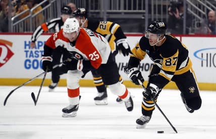 Feb 25, 2024; Pittsburgh, Pennsylvania, USA;  Pittsburgh Penguins center Sidney Crosby (87) controls the puck against the Philadelphia Flyers during the second period at PPG Paints Arena. Mandatory Credit: Charles LeClaire-USA TODAY Sports