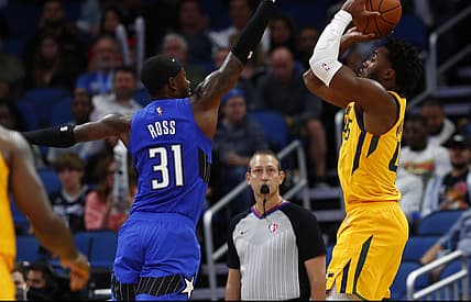 Nov 7, 2021; Orlando, Florida, USA; Utah Jazz guard Donovan Mitchell (45) shoots over Orlando Magic guard Terrence Ross (31) during the second quarter at Amway Center. Mandatory Credit: Kim Klement-USA TODAY Sports