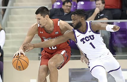 Dec 31, 2022; Fort Worth, Texas, USA;  Texas Tech Red Raiders forward Daniel Batcho (12) tries to control the ball as TCU Horned Frogs guard Mike Miles Jr. (1) defends during the first half at Ed and Rae Schollmaier Arena. Mandatory Credit: Kevin Jairaj-USA TODAY Sports